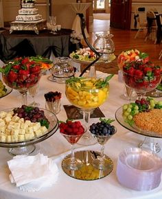 a table filled with lots of different types of food on top of glass dishes and plates