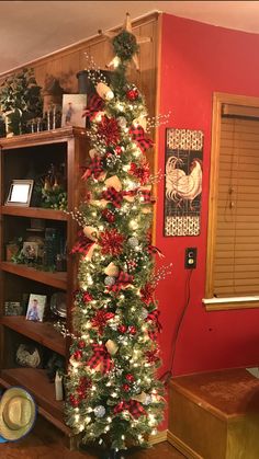 the christmas tree is decorated with red and white ornaments