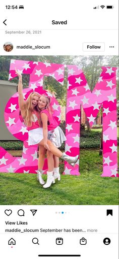 two girls posing in front of the word mom with stars on their chest and arms