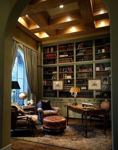 a living room filled with lots of furniture and bookshelves covered in bookcases