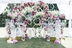 an outdoor wedding setup with flowers and lanterns