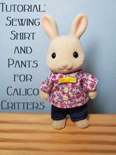 a stuffed rabbit wearing a shirt and pants