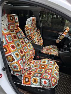 the interior of a car with crocheted blankets on it