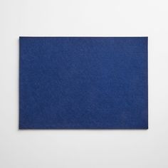 a blue piece of paper on a white surface