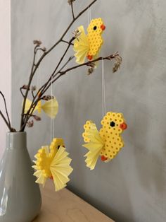 some yellow paper flowers are in a vase