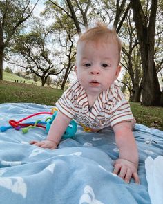 a baby laying on top of a blue blanket