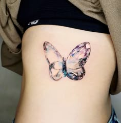 a woman's stomach with a butterfly tattoo on it