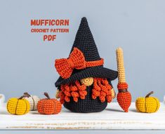 a crocheted witch's hat with pumpkins and corn on the side