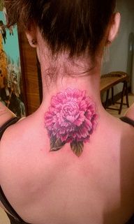 a woman with a pink flower tattoo on her neck