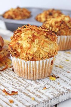 three muffins sitting on top of a wooden table