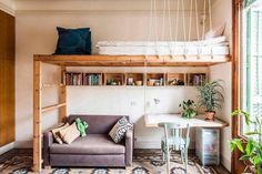 a living room with a couch, desk and bookshelf above the bunk bed