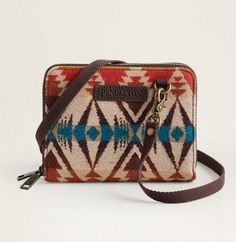 The Pendleton Crossbody Organizer is the perfect blend of style and functionality. Made with Pendleton's exclusive USA wool, it features multiple slots and an ID window for easy organization. With RFID protection, your belongings will stay secure. Plus, the unique pattern placement adds an extra touch of fun to this versatile accessory. Perfectly Organized, Coin Slot, Facebook Photos, Sales Tax, Leather Care, Wool Fabric, Cowhide Leather, Purse Wallet, Crossbody Bag