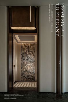 an elevator with marble walls and flooring next to two tall brown pillars in a room