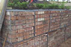 a pile of bricks sitting on top of a dirt field