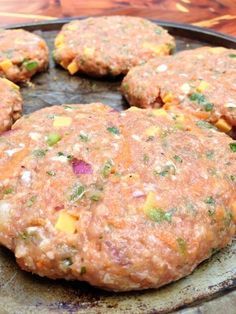 four hamburger patties on a pan ready to be cooked