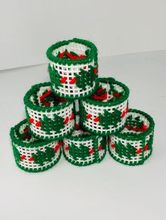 several pieces of green and white beaded christmas ribbon stacked on top of each other