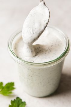 a spoon full of ranch dressing with parsley