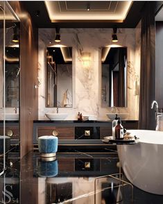 an elegant bathroom with marble counter tops and black walls, along with white bathtub