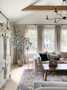 a living room filled with furniture and lots of windows