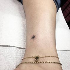 a small star tattoo on the ankle