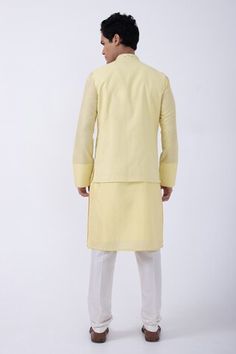 Yellow bam silk kurta with thread embroidered cuffs. Comes with ivory cotton silk pyjama and a suiting bundi jacket with cutdana work. - Aza Fashions Fitted Cotton Nehru Jacket With Gota Work, Cotton Nehru Jacket With Gota Work For Wedding, Eid Cotton Silk Nehru Jacket With Gota Work, Eid Nehru Jacket With Gota Work In Cotton Silk, Fitted Chanderi Nehru Jacket Straight Kurta, Cotton Nehru Jacket With Gota Work For Diwali, Kurta Set Men, Cutdana Embroidery, Cutdana Work