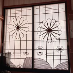 two decorative glass windows with designs on them