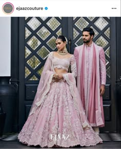 two people standing next to each other wearing pink outfits