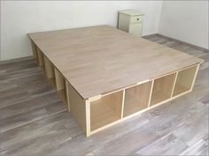 an empty room with wooden flooring and cabinets