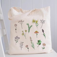 "Wildflower Tote Bag Floral Tote Bag Canvas Aesthetic Floral Print Tote Bag Flower Tote Farmers Market Eco Friendly Sustainable Bag  100% heavy cotton canvas. Product Size: 15\"W x 16\"H Machine washable, Eco-friendly, durable, recyclable Totes are perfect for carrying books, clothing, tradeshow goodies and more Bulk Discounts available. RETURNS/EXCHANGES: We do not accept returns as these are made to order just for you, BUT If for any reason you are not completely satisfied with your order, just send us a message and we'll sort out the issue as soon as possible. You can also purchase this design printed on a crewneck sweatshirt here: https://www.etsy.com/ca/listing/951161802/tpwk-treat-people-with-kindness-vsco?ref=shop_home_recs_18&pro=1&frs=1 Thank you for stopping by my shop! if you ha Green Floral Print Tote Bag, Everyday Floral Print Tote Bag, White Large Capacity Flower-shaped Shoulder Bag, White Flower-shaped Large Capacity Shoulder Bag, White Flower Shaped Shoulder Bag With Large Capacity, Green Floral Print Shoulder Bag, Everyday Floral Print Shoulder Bag, White Flower Shoulder Bag For Everyday Use, White Flower-shaped Shoulder Bag For Everyday Use