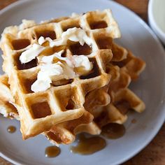 waffles with syrup and whipped cream on a plate