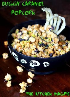 a bowl filled with popcorn and skeleton bones