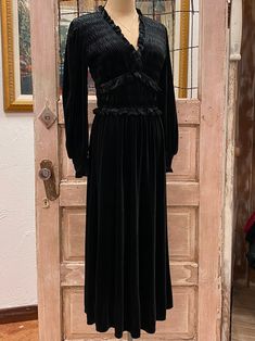 This Black Velvet Smocked Midi Dress is a timeless staple with its A-Line silhouette and a midi length skirt. Accented with a smocked bodice and ruffle trim, it's crafted from a luxurious blend of 92% Polyester and 8% Spandex for a comfortable fit. Perfect for formal and semi-formal events. Lily Grace, Midi Length Skirts, Ruffle Trim, Semi Formal, Black Velvet, Formal Event, Midi Length, Smocking, Bodice