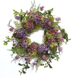 a wreath with purple flowers and green leaves