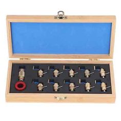 a wooden box with many different types of valves in it