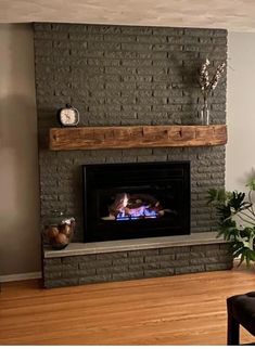 a living room with a brick fireplace and wood floors