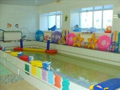 an indoor swimming pool with toys in it