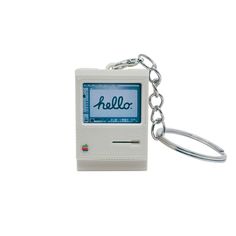 an apple computer keychain with the word hello written on it's screen