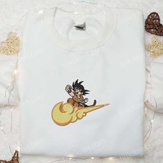 Songoku x Cloud Nike Swoosh Embroidered Shirt, Dragon Ball Z Anime Embroidered Hoodie, Nike Inspired Embroidered Sweatshirt Welcome to Tinicloset, the iconic destination for those who crave more than just clothing; they seek a statement, an expression, an embodiment of their passions. At Tinicloset, we specialize in crafting custom embroidered shirts, sweatshirts, T-shirts, and hoodies that transcend mere garments and transform into pieces of art. Our signature products, the Songoku x Cloud Nike White Hooded Top With Machine Embroidery, Crew Neck Hoodie With Machine Embroidery For Streetwear, White Sweatshirt With Machine Embroidery For Streetwear, White Embroidered Hooded Hoodie, White Hooded Hoodie With Embroidered Patch, Long Sleeve Hoodie With Machine Embroidery For Streetwear, Long Sleeve Hoodie With Embroidery For Streetwear, Long Sleeve Sweatshirt With Machine Embroidery For Streetwear, Long Sleeve Embroidered Sweatshirt For Streetwear