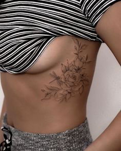 a woman with a flower tattoo on her stomach