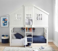 a child's bedroom with white bunk beds and blue bedding