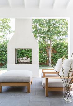 a living room with two couches and a fire place in the middle of it