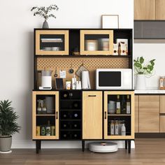 a kitchen area with a microwave, cabinets and potted plant in the corner on the floor