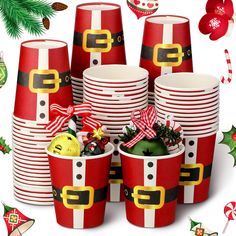 many red and white paper cups with santa's hats on them are surrounded by christmas decorations