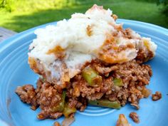 a blue plate topped with mashed potatoes and meat