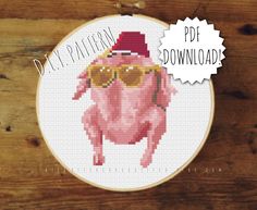 a cross stitch pig wearing sunglasses and a hat