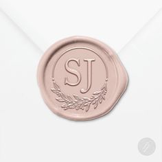 a wax stamp with the letter j on it