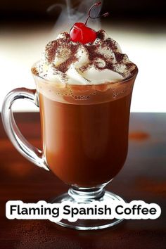 a hot chocolate drink with whipped cream and a cherry garnish in the top