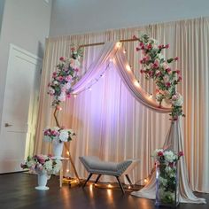 a wedding arch decorated with flowers and lights