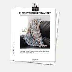 the chunk crochet blanket pattern is shown on top of two folded papers with scissors