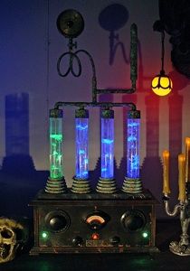 an old fashioned machine with many lights on it's sides and some candles in front of it